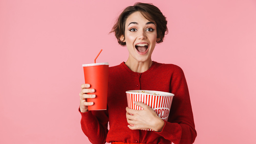 woman with soda and popcorn
